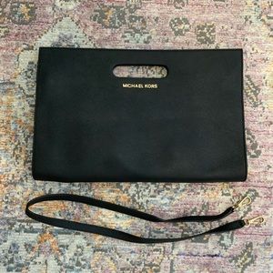 MICHAEL by Michael Kors black oversized clutch with shoulder strap.